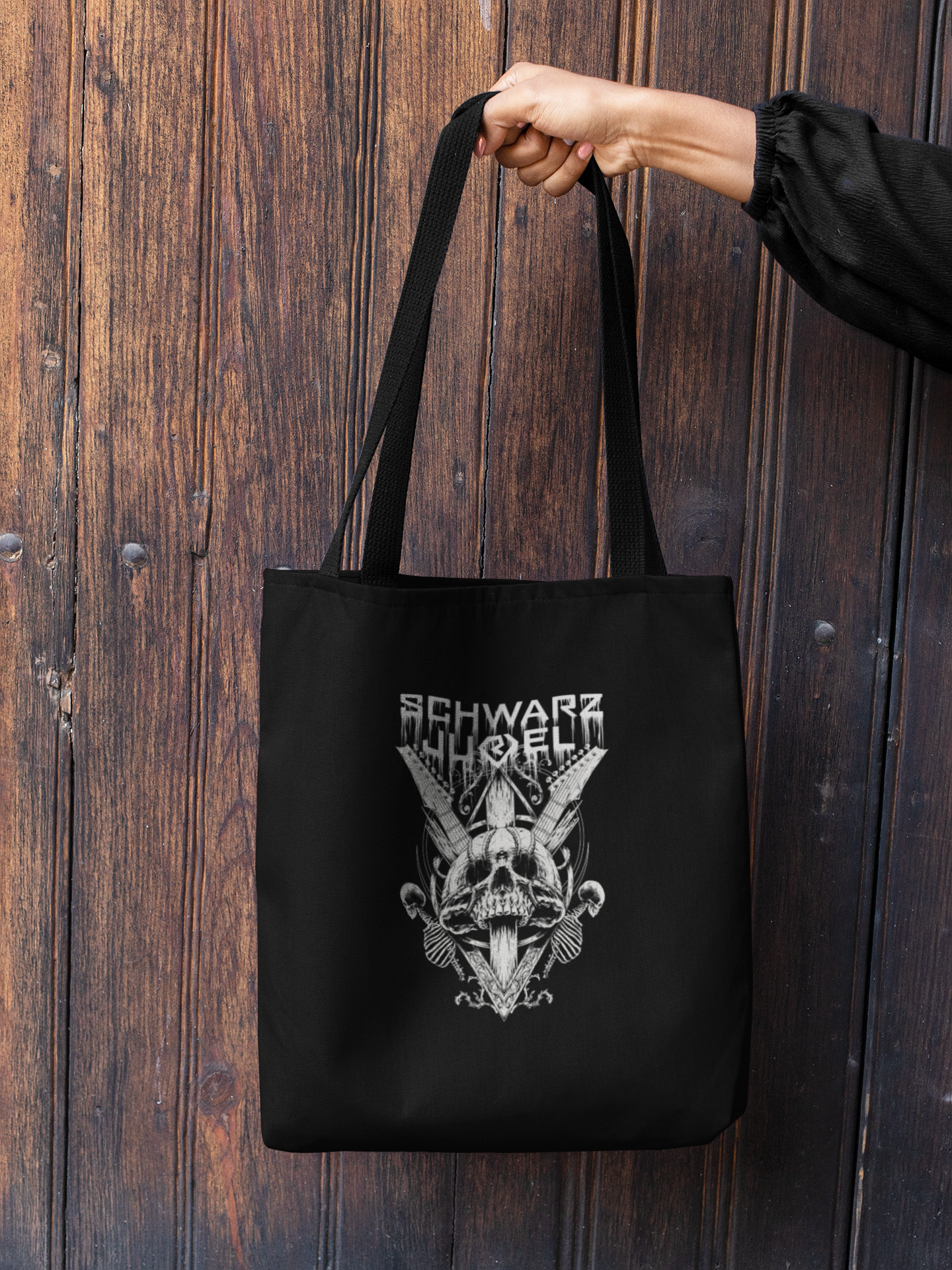 mockup-of-a-woman-s-hand-holding-a-tote-bag-against-a-wooden-background-26693.png